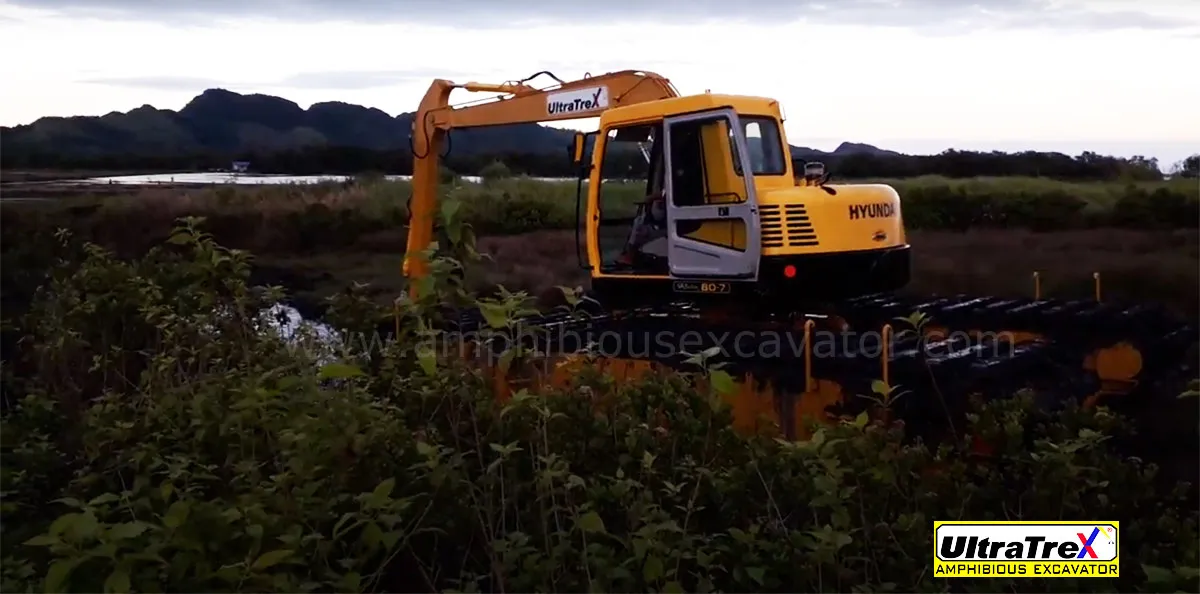 Ultratrex AT90ER amphibious excavator is in action to expand and deepen the pond for breeding fish.